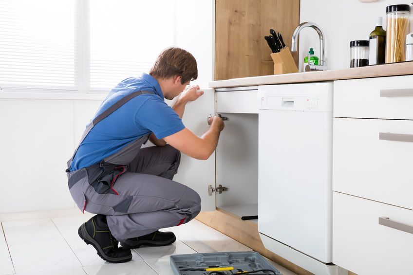 Repairman Repairing Cabinet Hinge